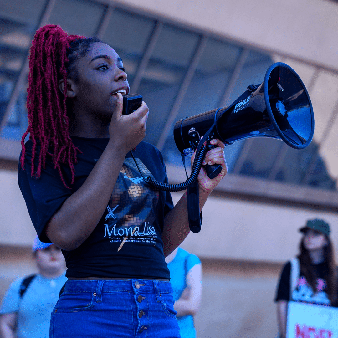 Activist speaking through microphone at rally