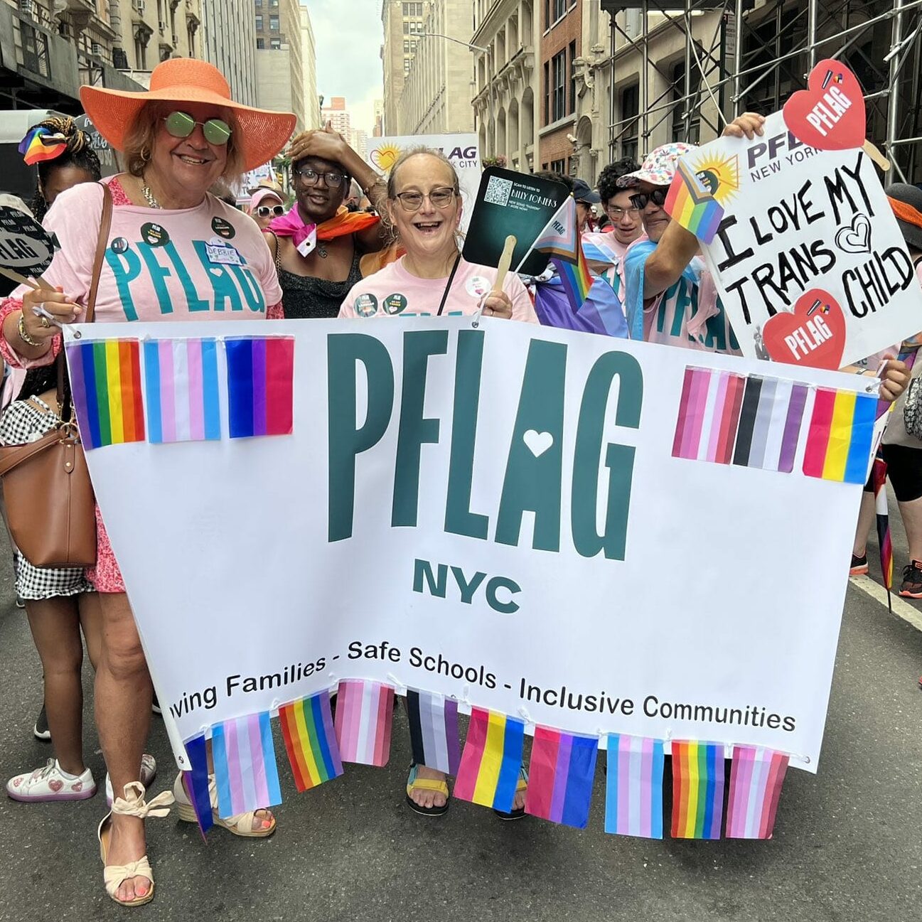 PFLAG members at a rally in New York City holding sign reading 