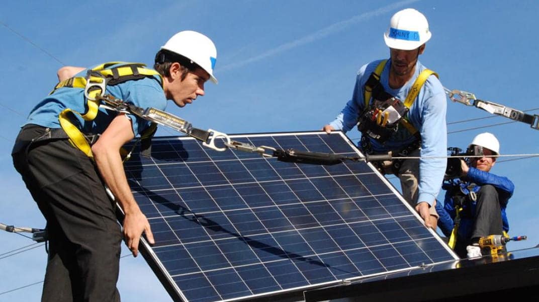 People installing solar panel