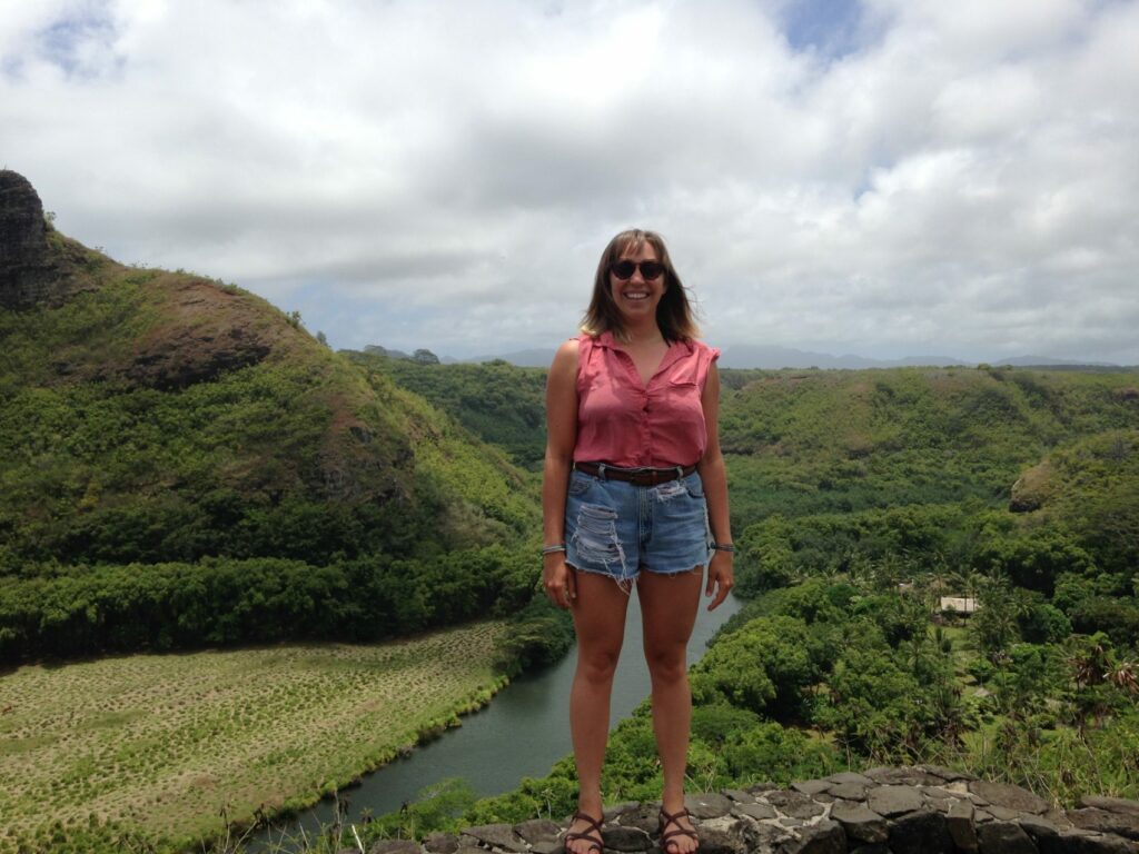 Mia standing in front of green landscape