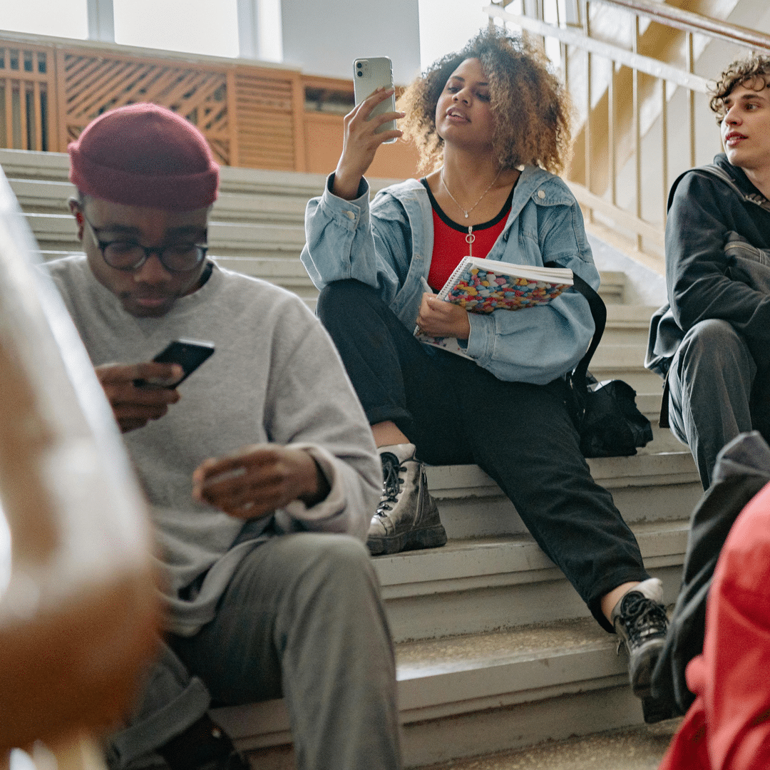 Diverse group of students sitting on staircase