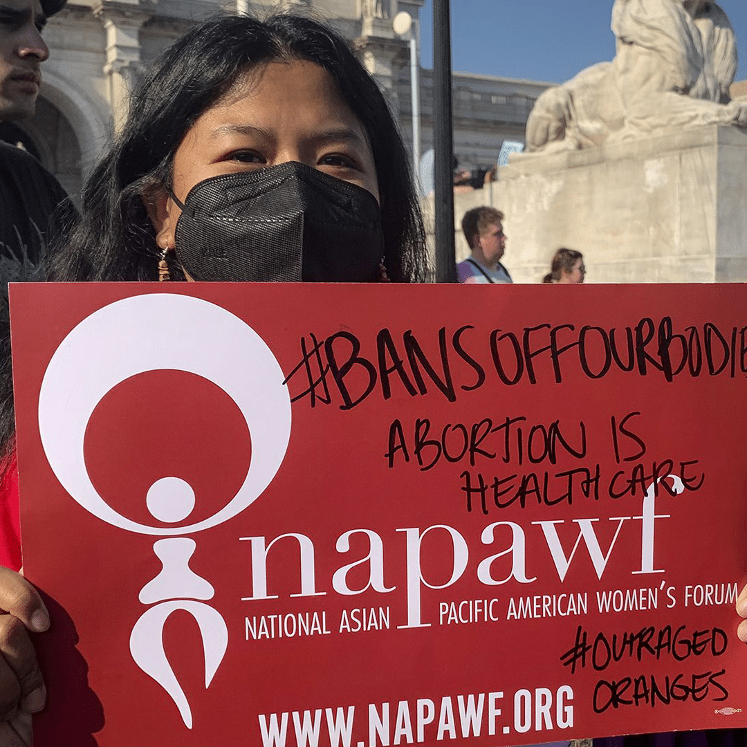 NAPAWF member holding sign reading 