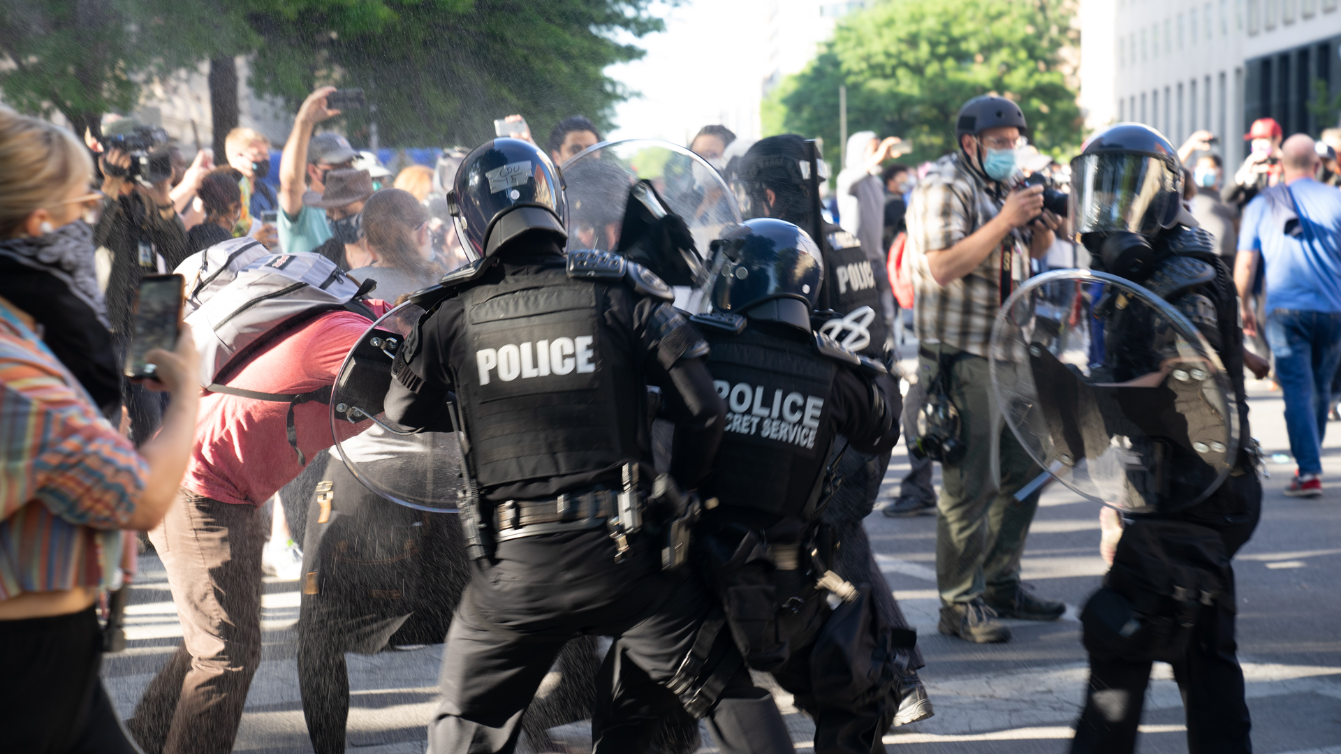 Group of police officers clashing with a crowd of protesters at 2020 George Floyd riot in DC