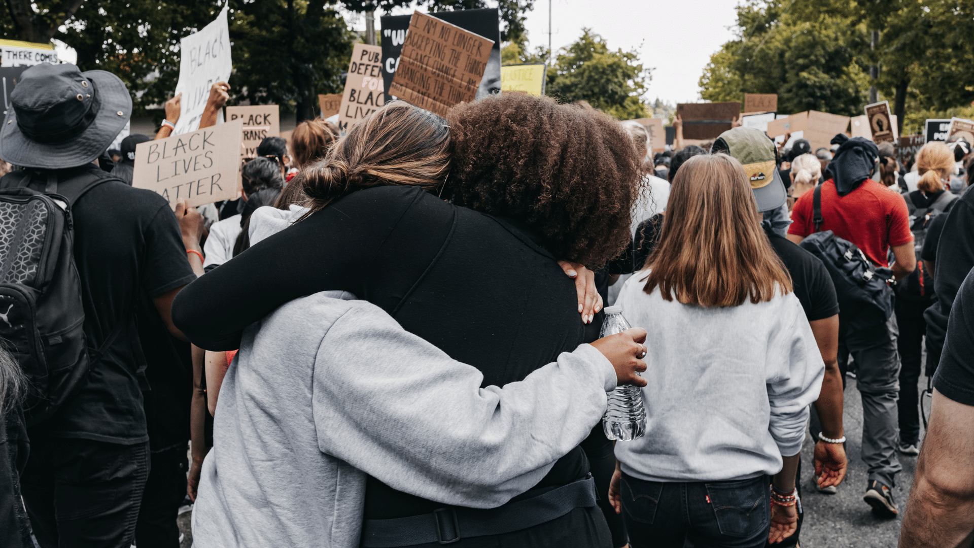 Two people hugging at a Black Lives Matter rally
