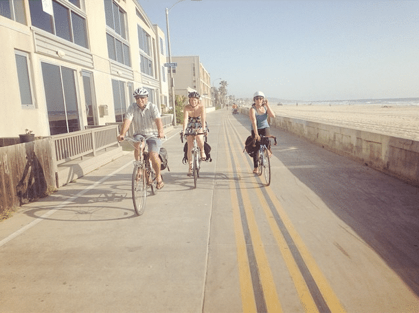 Mixte team biking near the beach