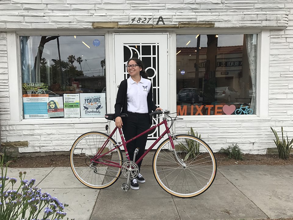 Mixte staff with bike in front of office