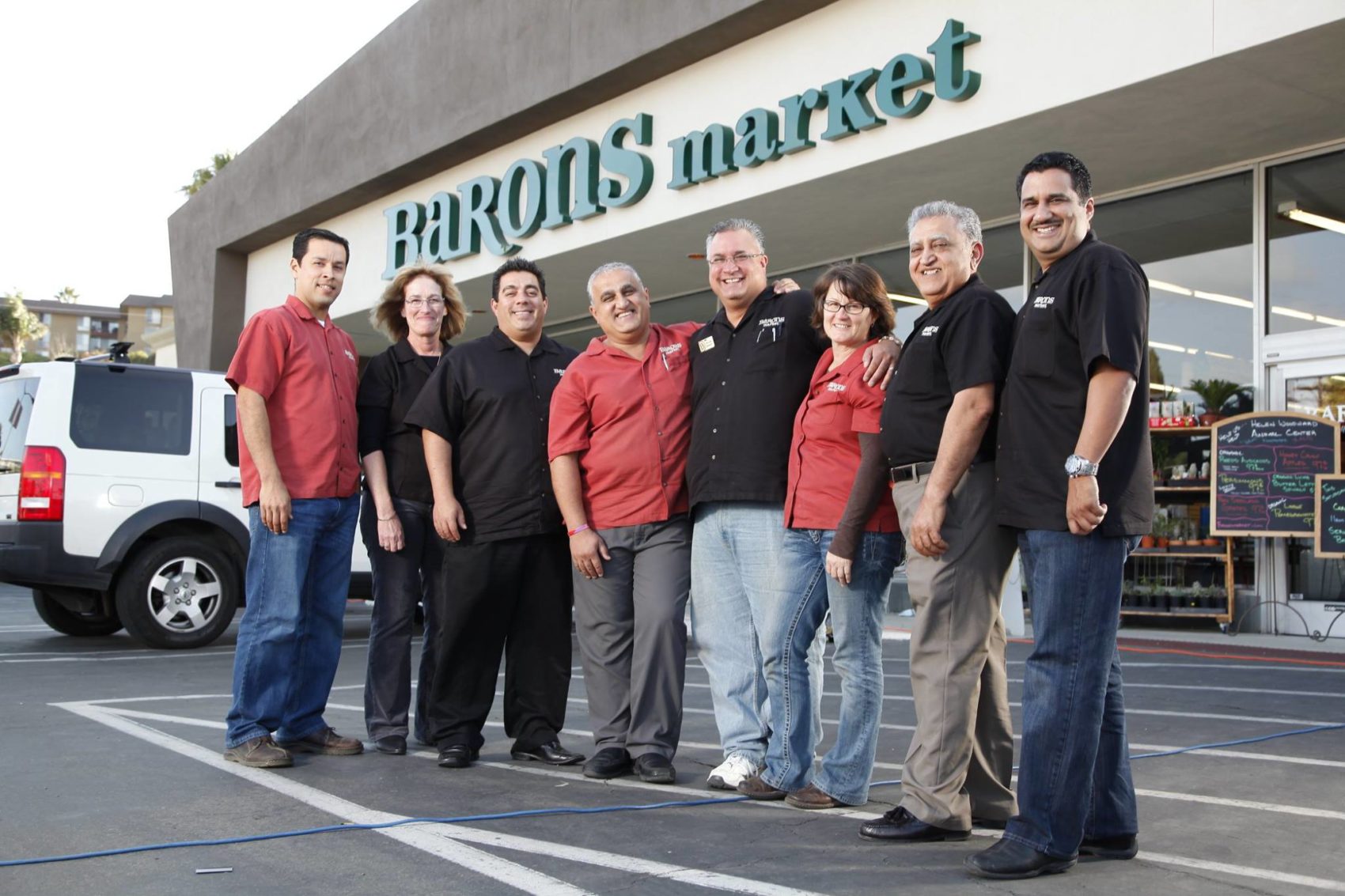 Barons staff standing in front of market