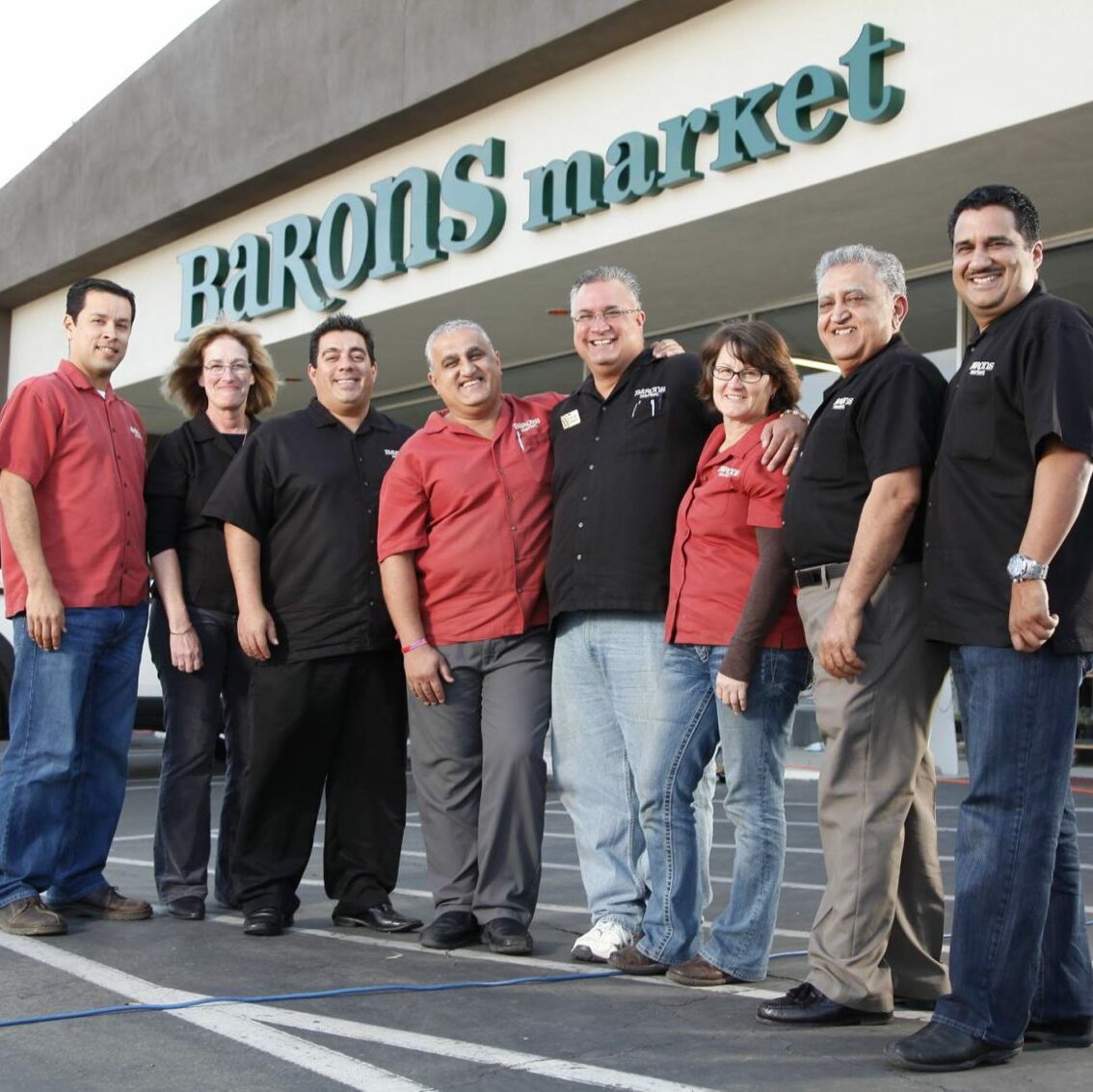 Barons staff standing in front of market