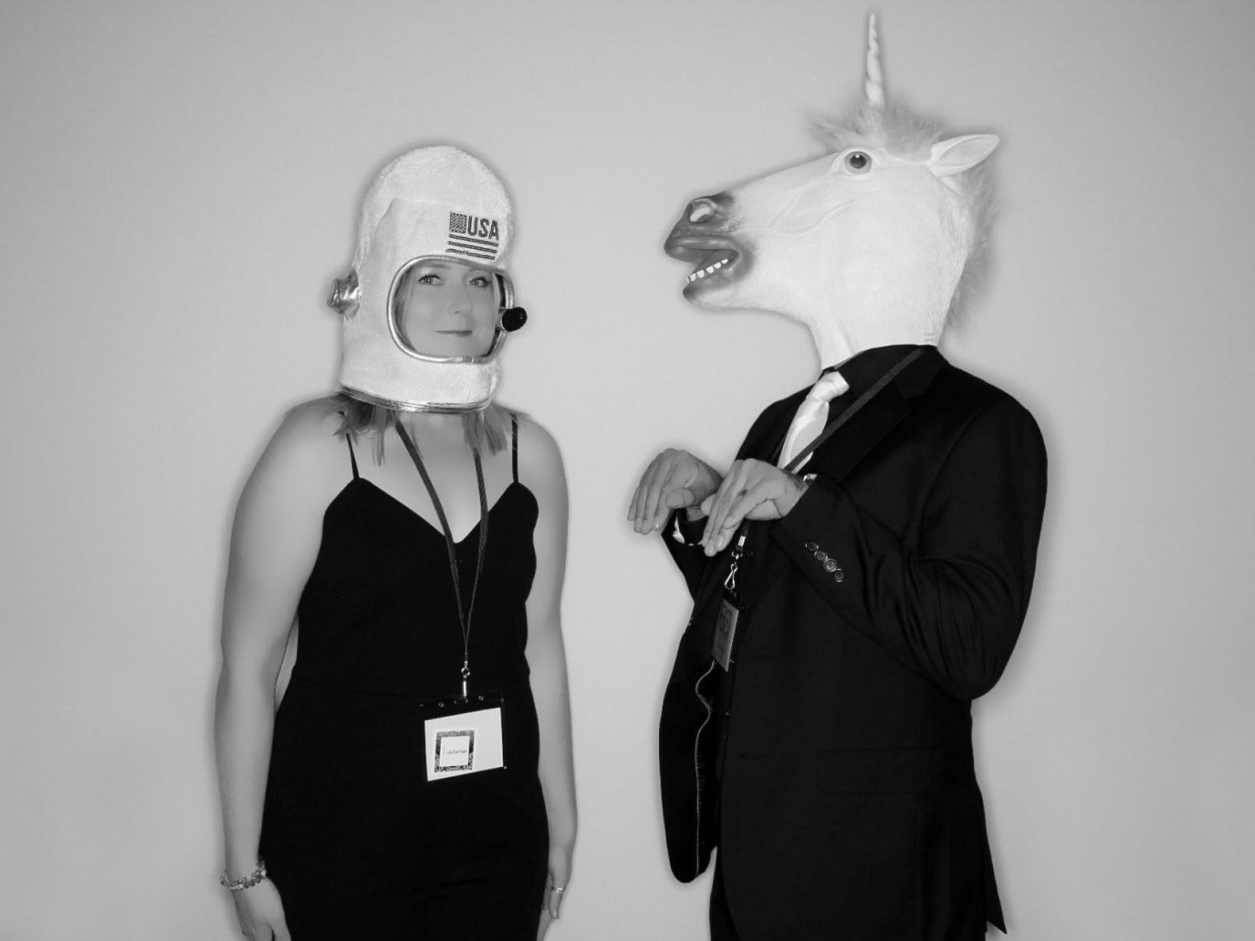 Two Mixte staff wearing silly costumes at photo booth